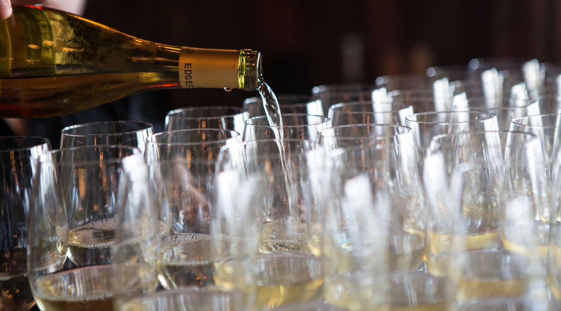 Closeup of wine being poured into glasses